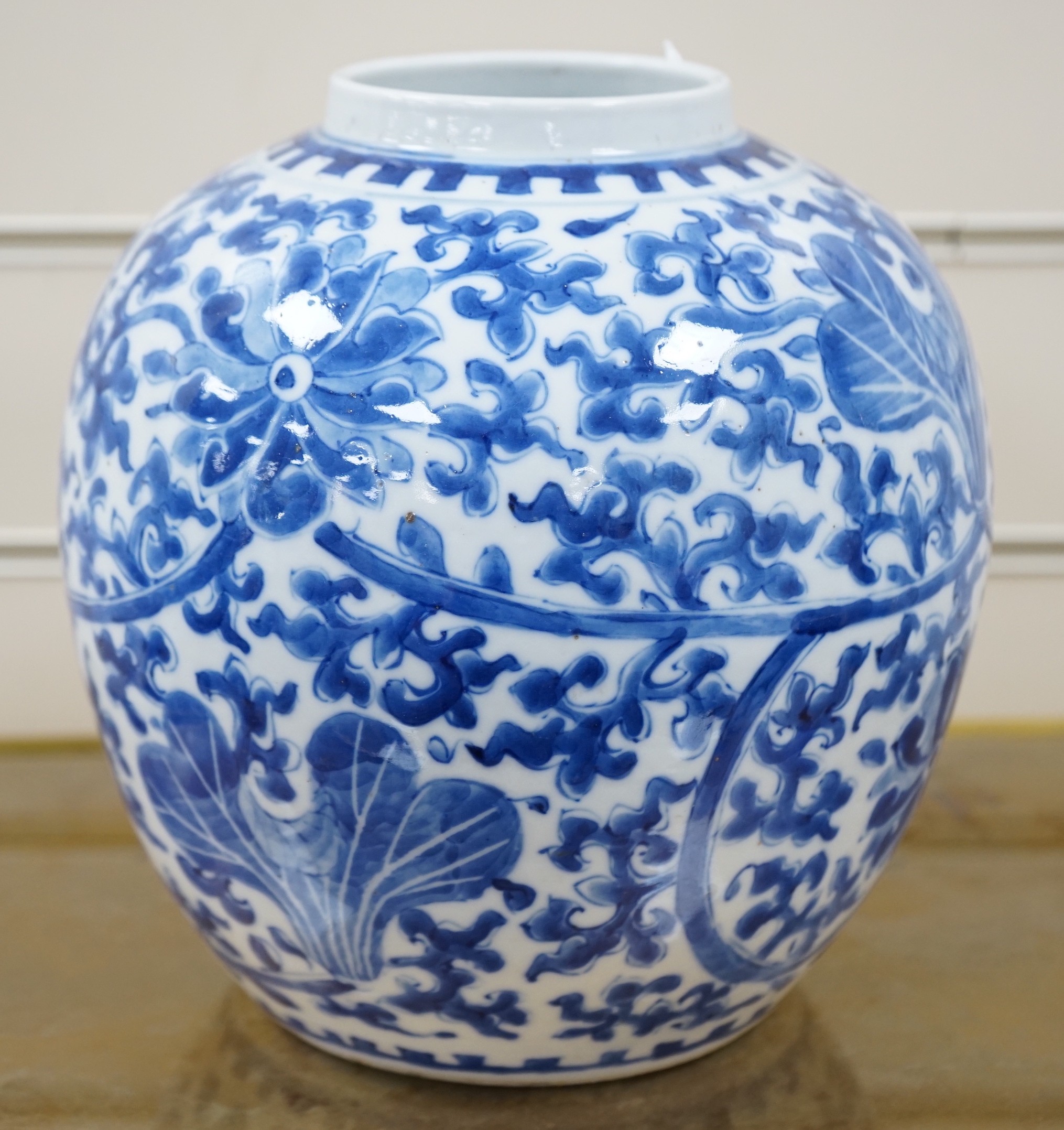 A late 19th century Chinese blue and white ovoid jar. 22cm tall, apocryphal Kangxi mark